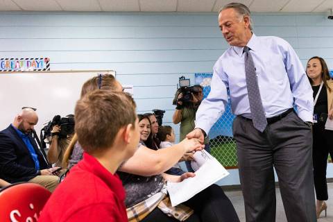 Gov. Joe Lombardo shakes hands with students at Mountain View Christian School and their parent ...