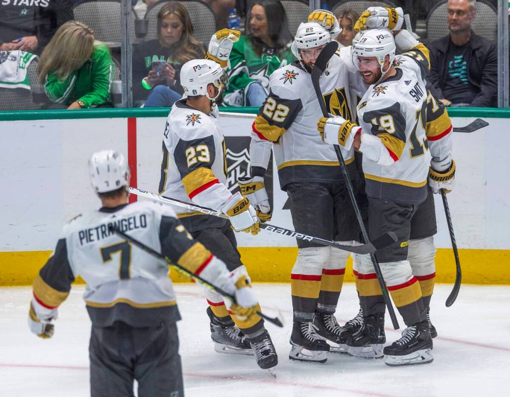 Golden Knights players celebrate another score on Dallas Stars goaltender Jake Oettinger (29) d ...