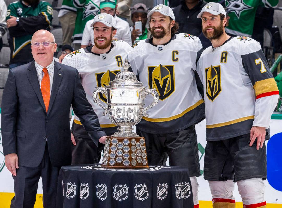 Bill Daly, Deputy commissioner of the NHL, awards the trophy to the Golden Knights after defeat ...