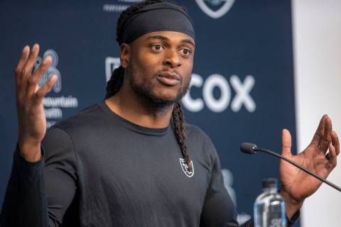 Raiders wide receiver Davante Adams gestures as he answers a question during a news conference ...