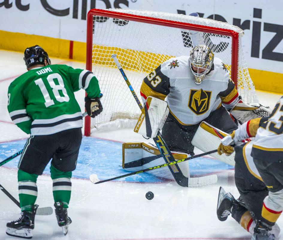 Golden Knights goaltender Adin Hill (33) rejects a shot by Dallas Stars center Max Domi (18) du ...