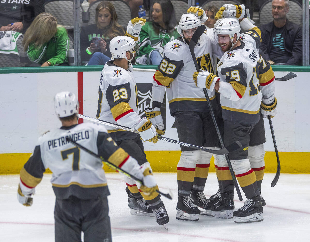 Golden Knights players celebrate another score on Dallas Stars goaltender Jake Oettinger (29) d ...