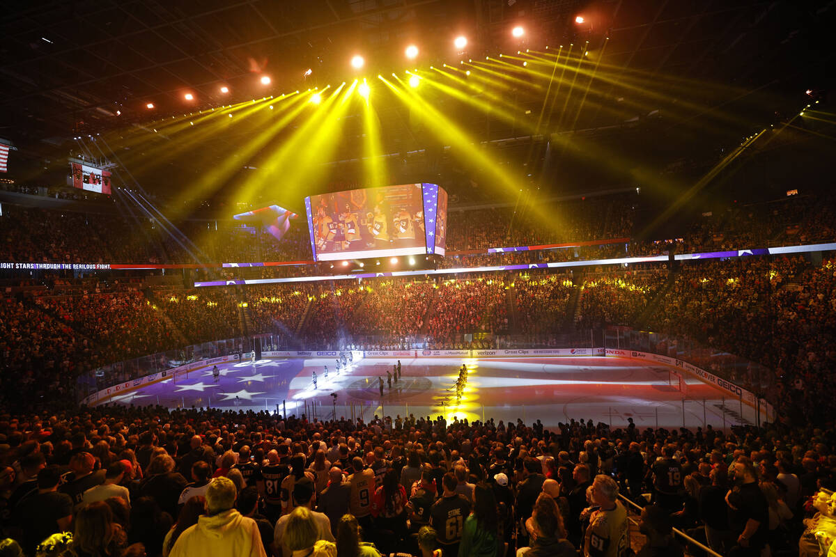 Golden Knights players and Dallas Stars players stand for the national anthem before the Game 2 ...