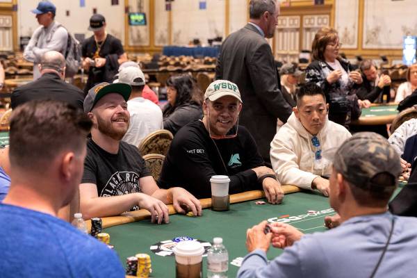 Players laugh at their table during the first day of the World Series of Poker at Horseshoe Las ...