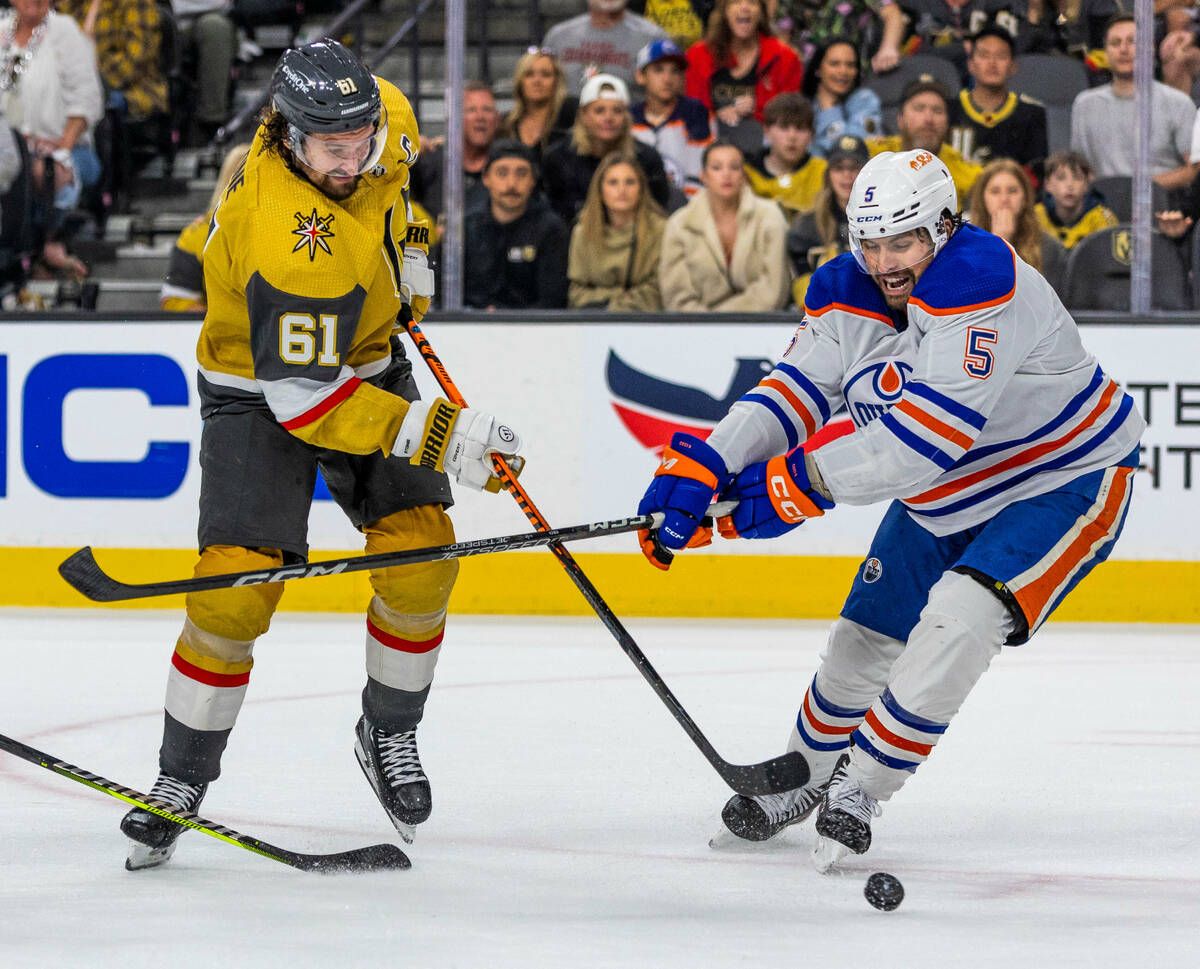 Golden Knights right wing Mark Stone (61) shoots past Edmonton Oilers defenseman Cody Ceci (5) ...