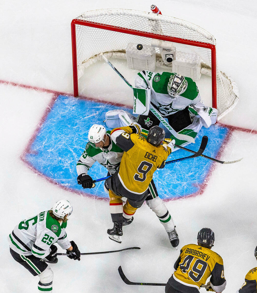 Golden Knights center Jack Eichel (9) collides with Dallas Stars defenseman Esa Lindell (23) as ...