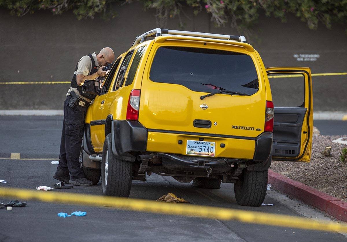 Metro Senior Crime Scene Analyst Joseph Szukiewicz works the scene of a homicide at the Solaire ...