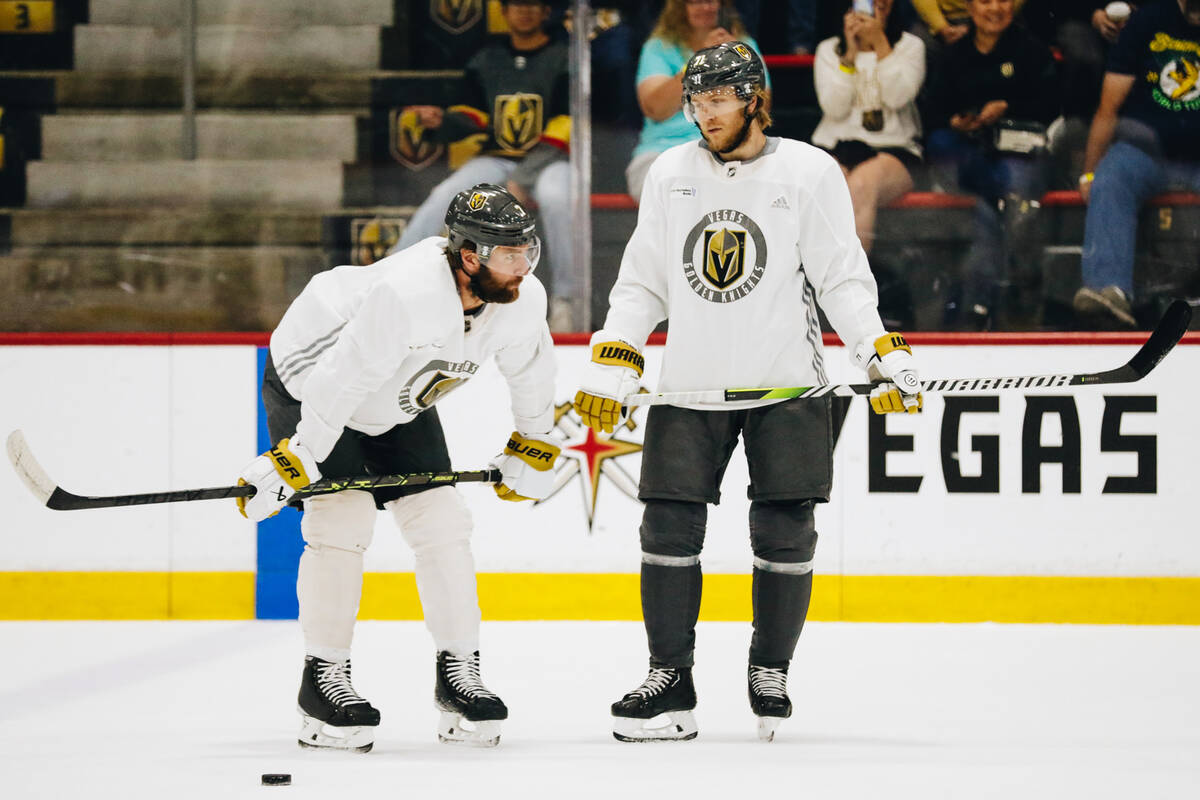 Golden Knights defenseman Alex Pietrangelo, left, speaks with his teammate, center William Karl ...