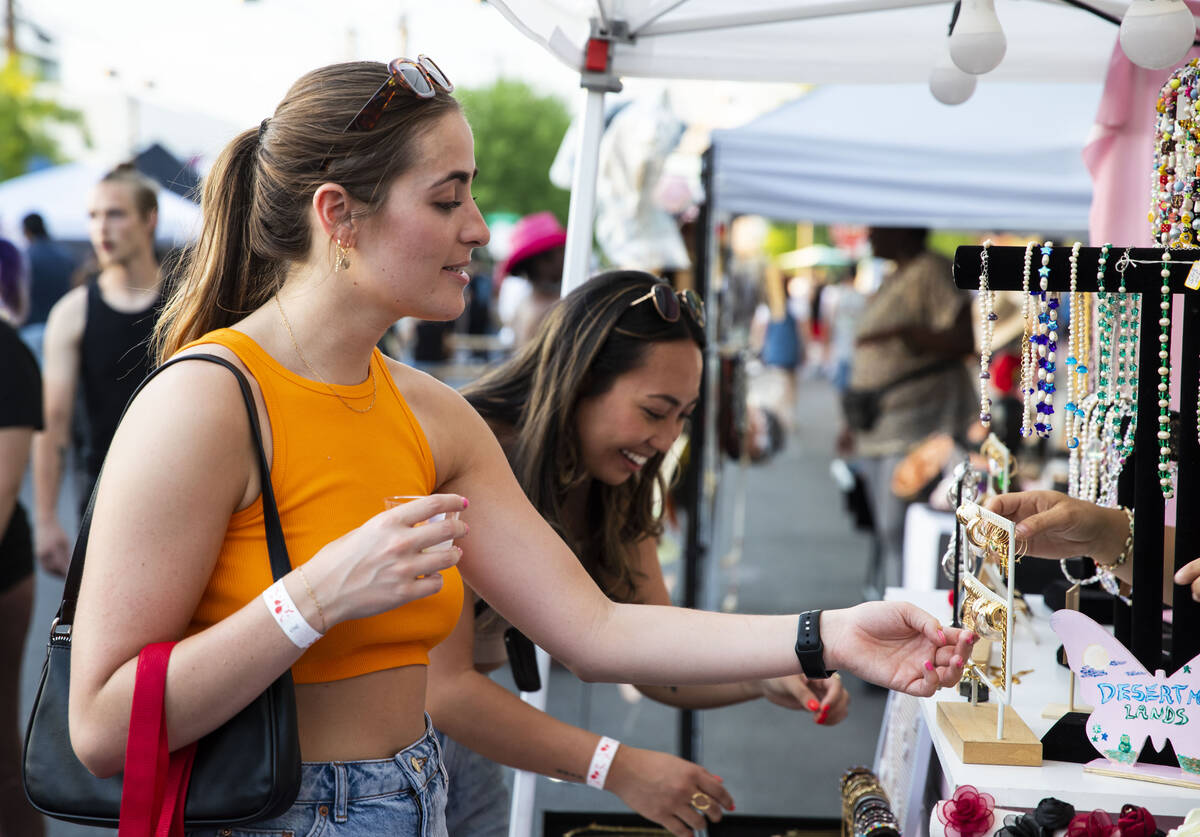 Hannah Barnett, left, and Tara Okui shop at Vanessa Otto’s Desert Moon jewelry booth at ...