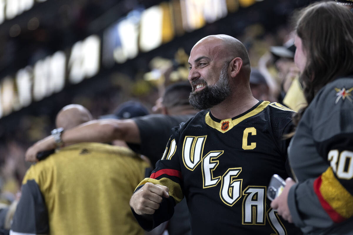 A Golden Knights fan celebrates after Knights defenseman Zach Whitecloud (2) scored during the ...