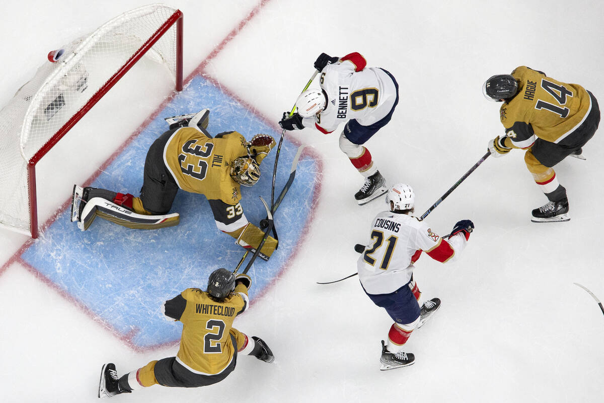 Golden Knights goaltender Adin Hill (33) and defenseman Zach Whitecloud (2) defend the net agai ...