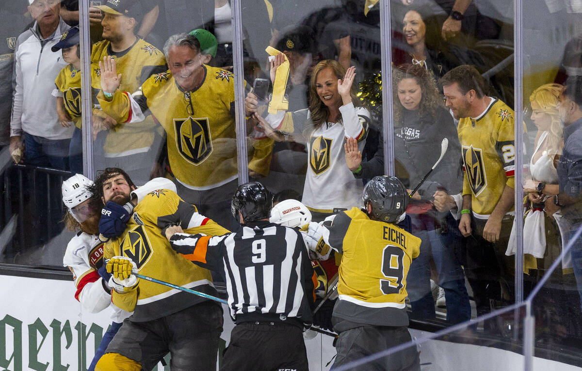 Golden Knights defenseman Nicolas Hague (14) is restrained by Florida Panthers defenseman Marc ...