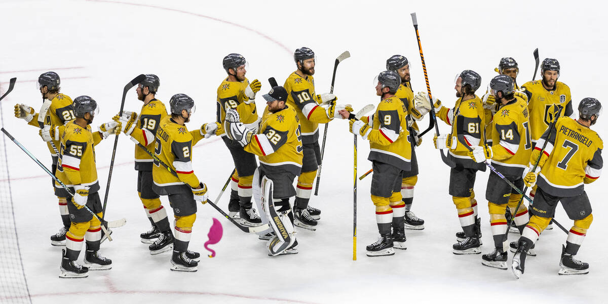 Golden Knights players celebrate a 5-2 win against the Florida Panthers in Game 1 of the NHL ho ...