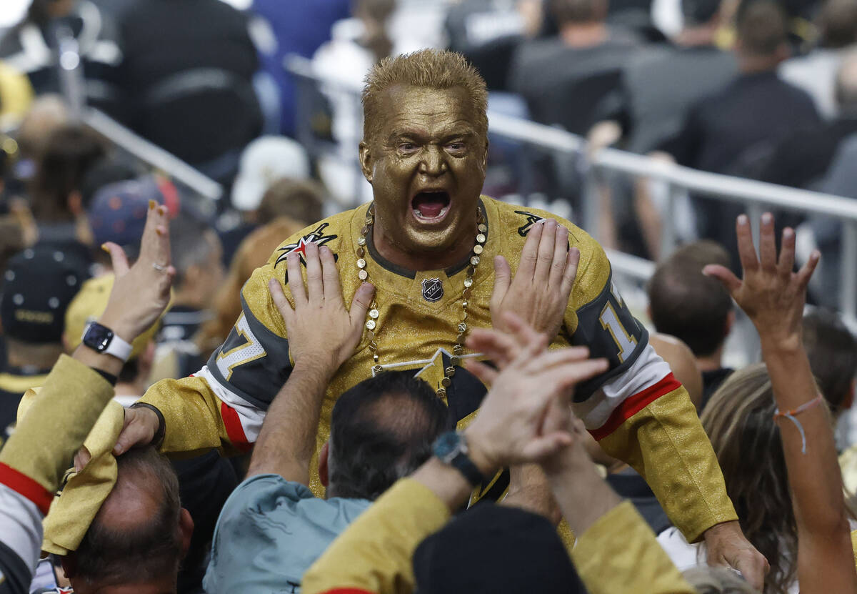 A Golden Knights fan cheers during the second period in Game 1 of the NHL hockey Stanley Cup Fi ...