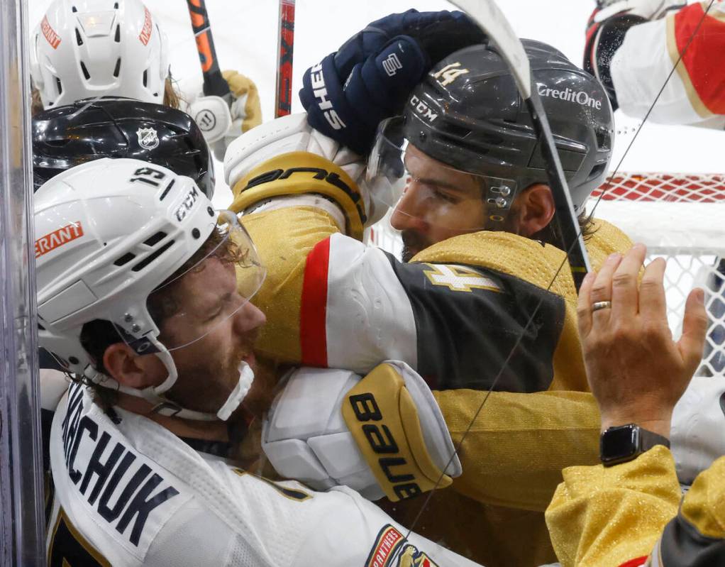 Florida Panthers left wing Matthew Tkachuk (19) fights with Golden Knights defenseman Nicolas H ...