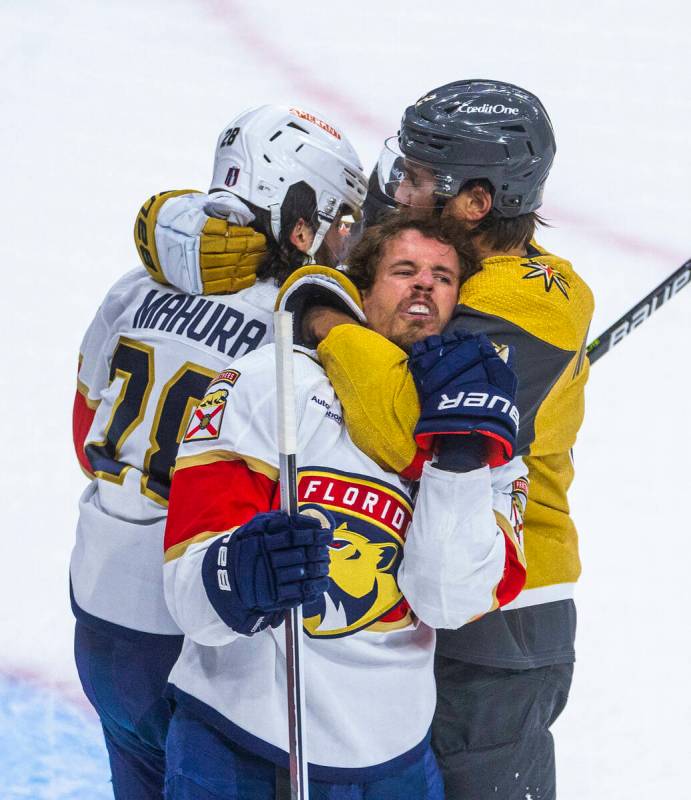 Florida Panthers center Eetu Luostarinen (27) is strangled by Golden Knights defenseman Zach Wh ...