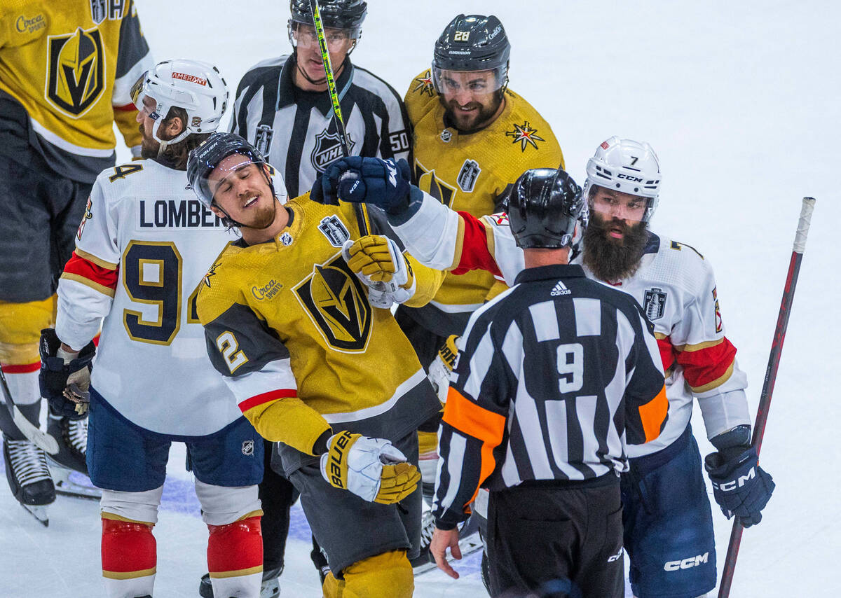 Golden Knights defenseman Zach Whitecloud (2) takes a glove to the face from Florida Panthers d ...