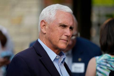 FILE - Former Vice President Mike Pence talks with local residents during a meet and greet on M ...
