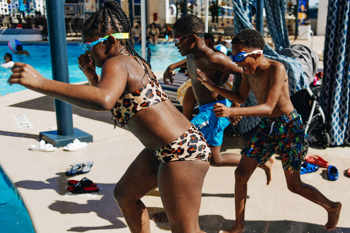 Daziya Smothers, left, Terell Durham, middle, and Devonte Smothers, 11, run into the pool on Fr ...