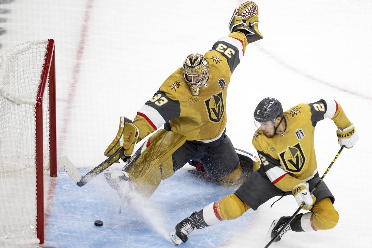 Golden Knights goaltender Adin Hill (33) and defenseman Zach Whitecloud (2) can’t save t ...