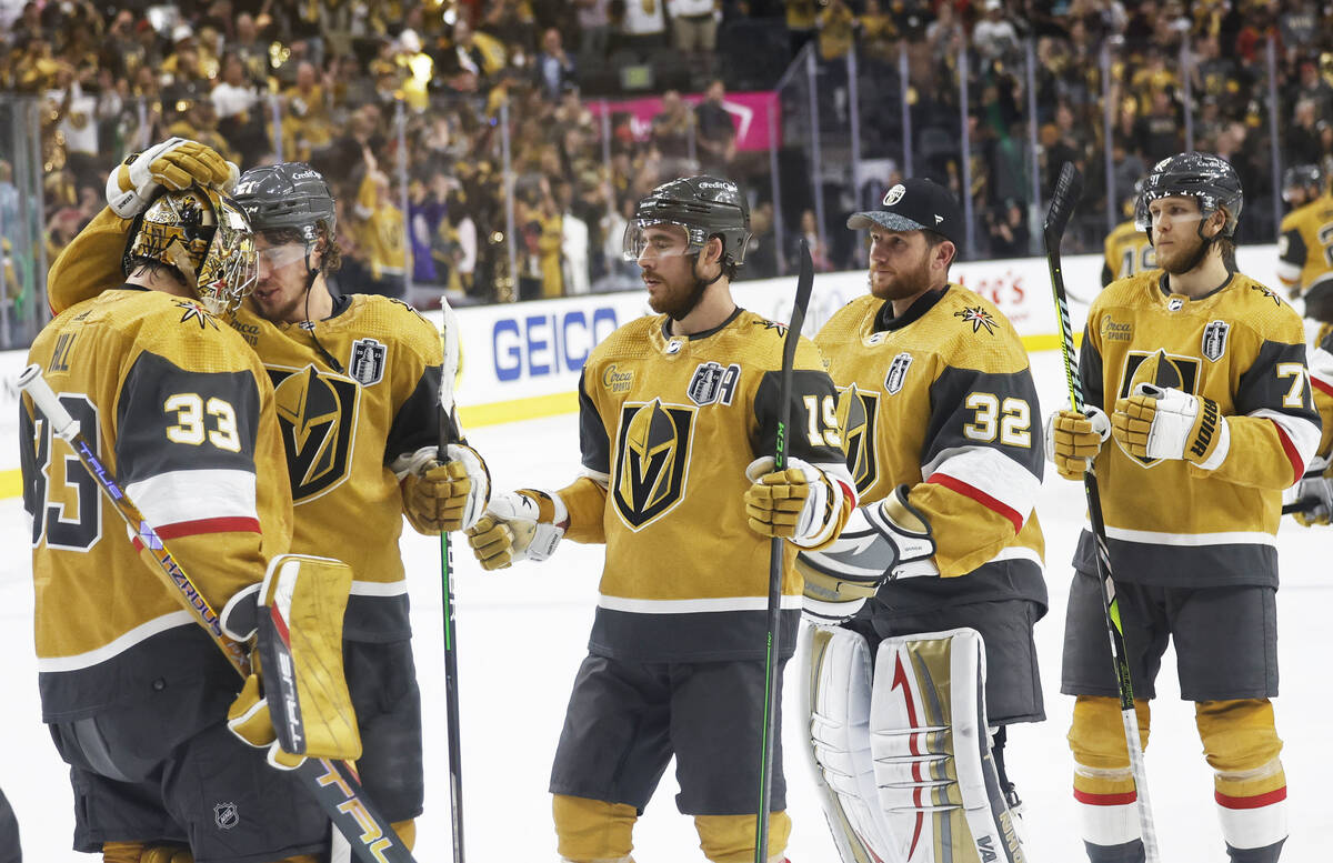 Golden Knights goaltender Adin Hill (33) is congratulated by Golden Knights center Brett Howden ...