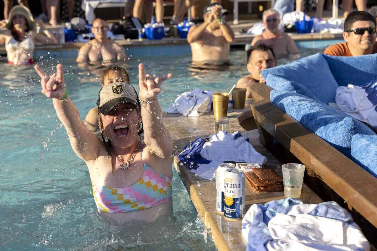 A Golden Knights fan celebrates after her team scored on the Florida Panthers during a watch pa ...