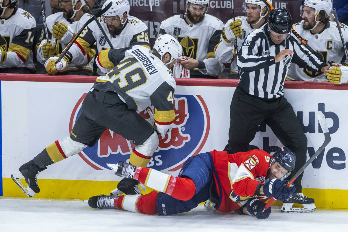 Golden Knights center Ivan Barbashev (49) knocks Florida Panthers defenseman Aaron Ekblad (5) t ...