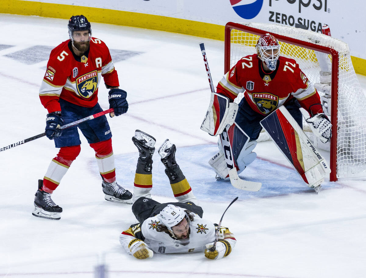 Golden Knights right wing Mark Stone (61) is checked to the ice by Florida Panthers defenseman ...