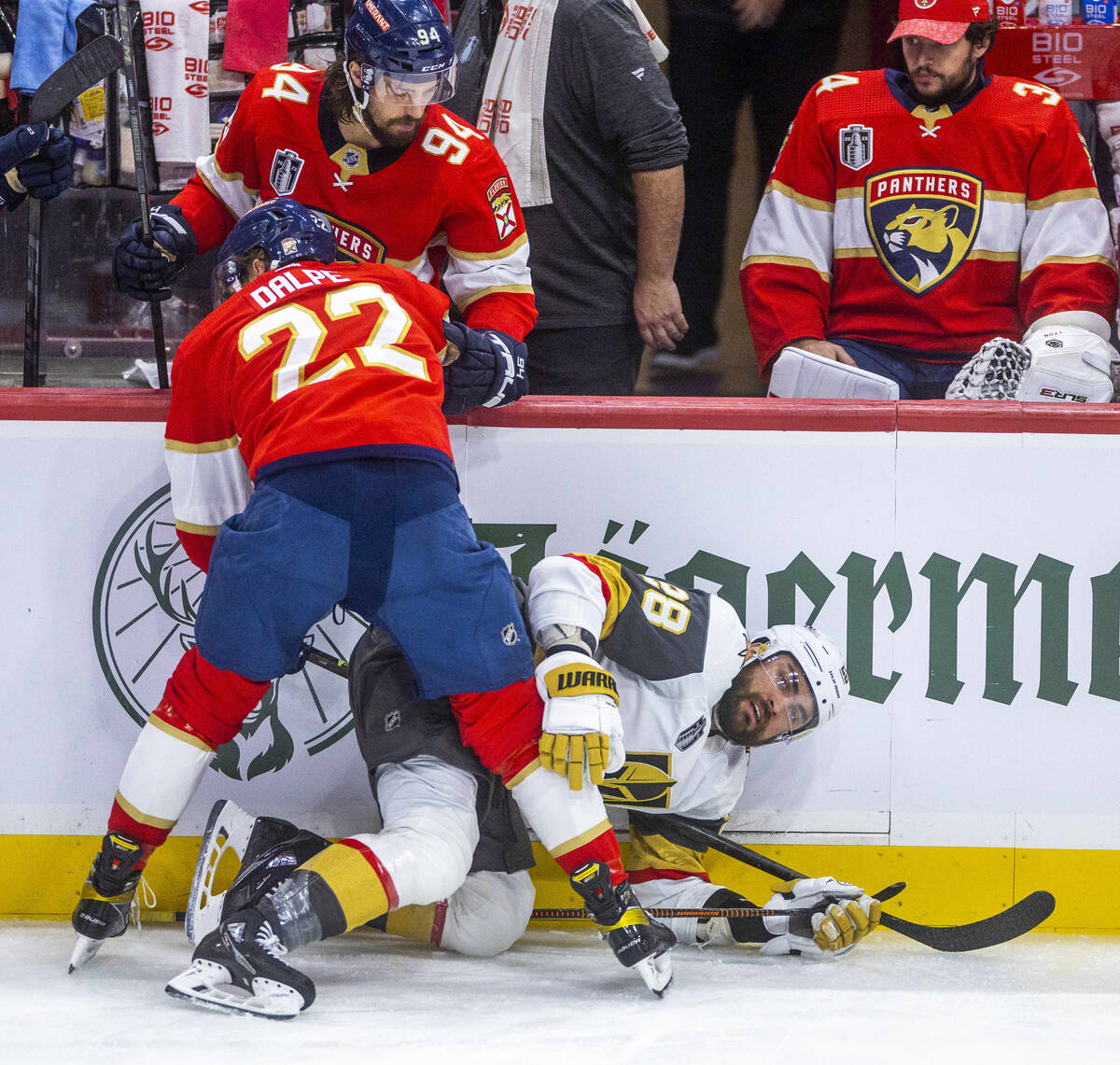 Golden Knights left wing William Carrier (28) is held down after a check to the ice by Florida ...