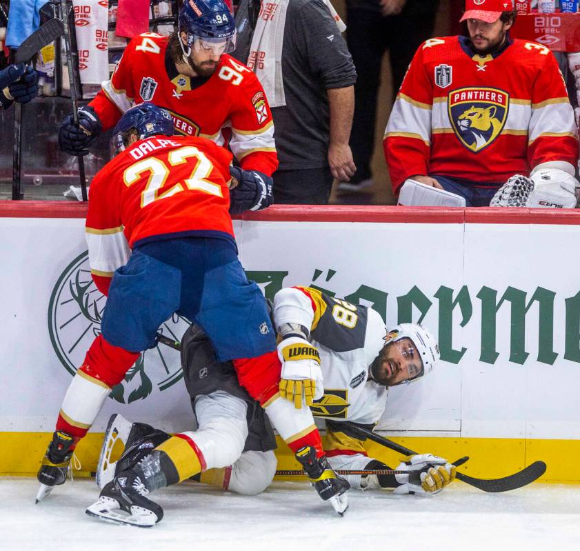 Golden Knights left wing William Carrier (28) is held down after a check to the ice by Florida ...