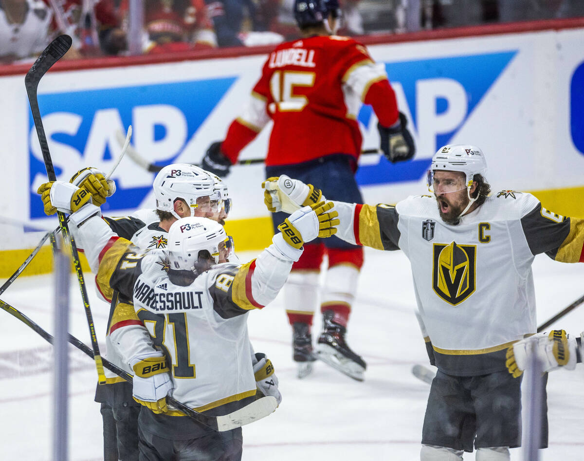 Golden Knights right wing Mark Stone (61) comes to celebrate a goal with right wing Jonathan Ma ...