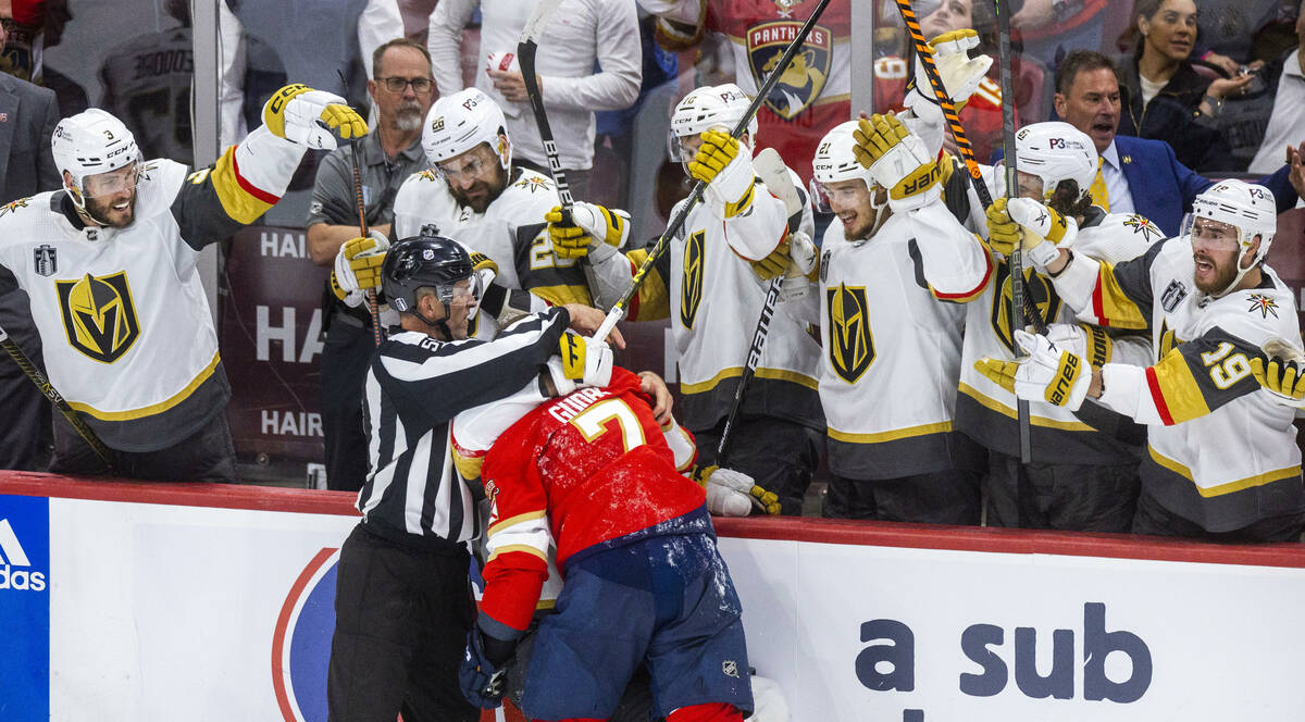 Golden Knights defenseman Zach Whitecloud (2) and Florida Panthers defenseman Radko Gudas (7) f ...