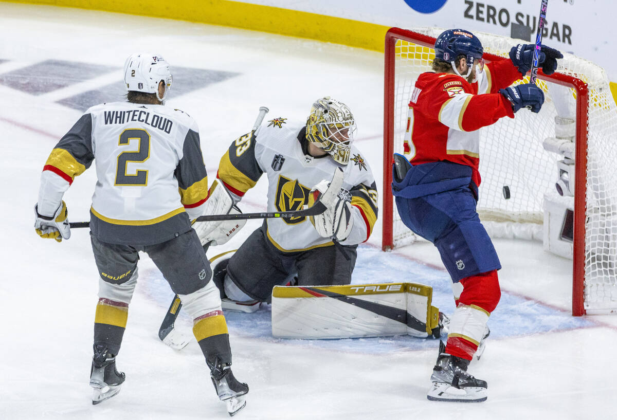 Golden Knights goaltender Adin Hill (33) looks back as a goal hits the net with Florida Panther ...