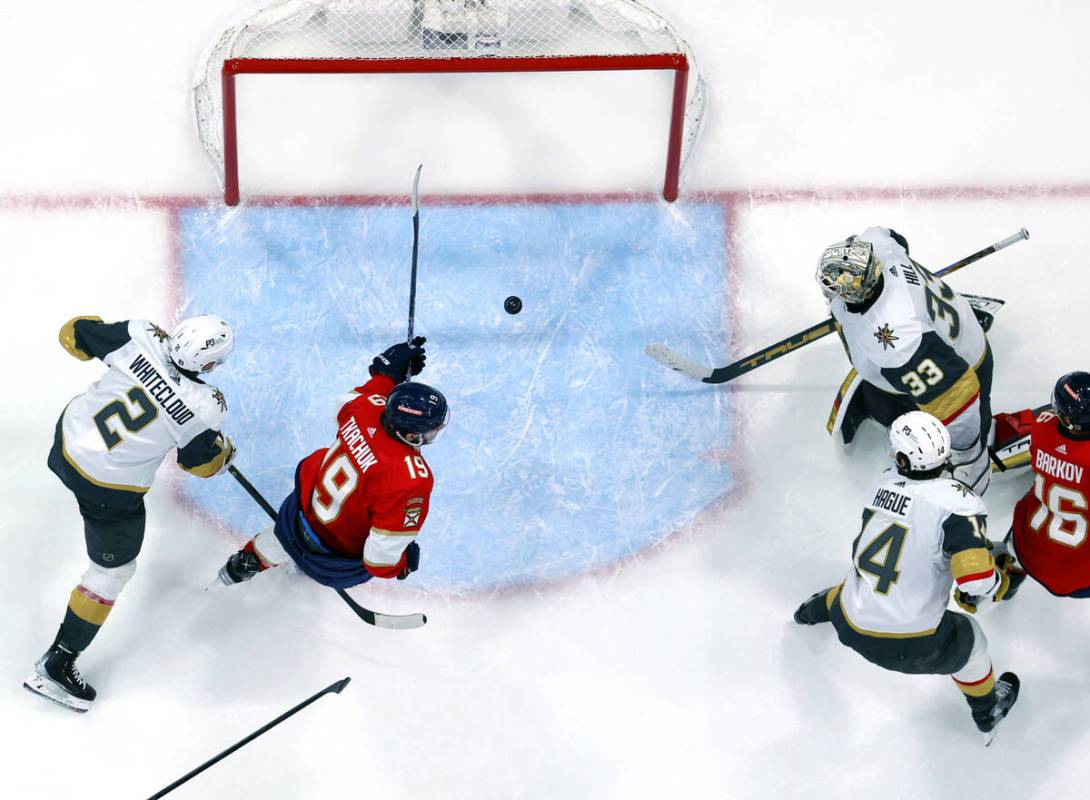 Florida Panthers left wing Matthew Tkachuk (19) scores as he splits Golden Knights defenseman Z ...