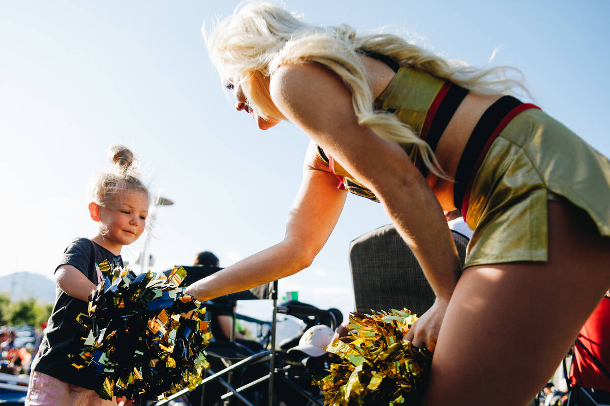 Ripley Warren, 3, left, shows her pompoms to Vegas Viva Beveling Prekop on Thursday, June 8, 20 ...