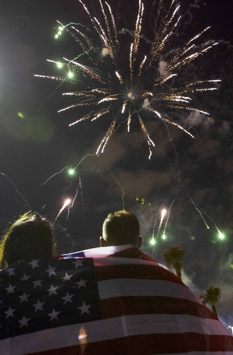 Elaine Fernandez, left, and her husband Ariel, both of Las Vegas, watch as fireworks go off abo ...