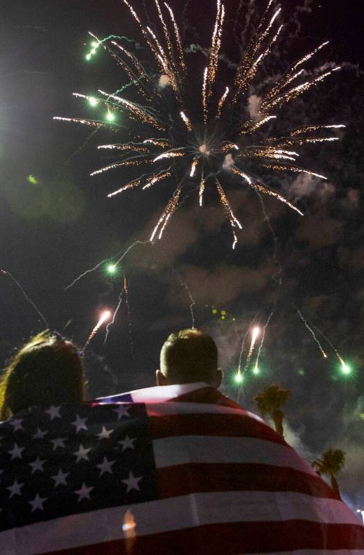 Elaine Fernandez, left, and her husband Ariel, both of Las Vegas, watch as fireworks go off abo ...