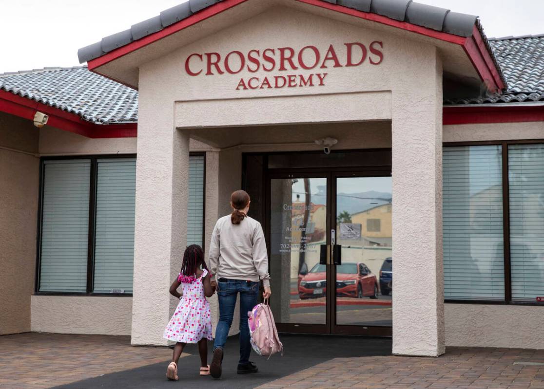 A girl is dropped off at the Crossroads Academy preschool on Wednesday, June 7, 2023, in Las Ve ...