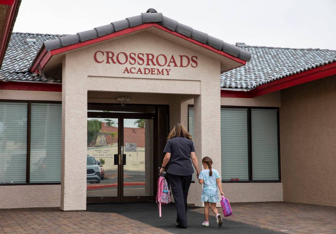 A girl is dropped off at the Crossroads Academy preschool on Wednesday, June 7, 2023, in Las Ve ...