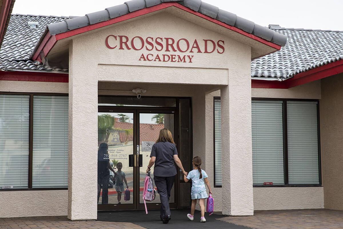 A girl is dropped off at the Crossroads Academy preschool on Wednesday, June 7, 2023, in Las Ve ...