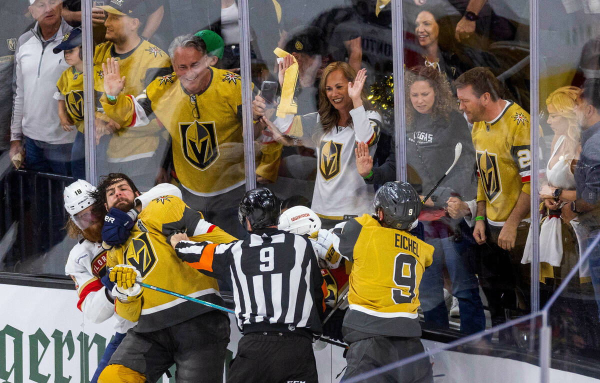 Golden Knights defenseman Nicolas Hague (14) is restrained by Florida Panthers defenseman Marc ...