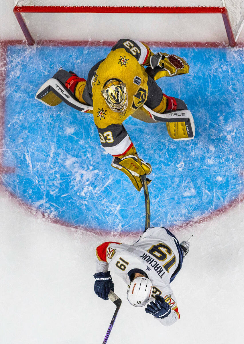 Golden Knights goaltender Adin Hill (33) smashes Florida Panthers left wing Matthew Tkachuk (19 ...