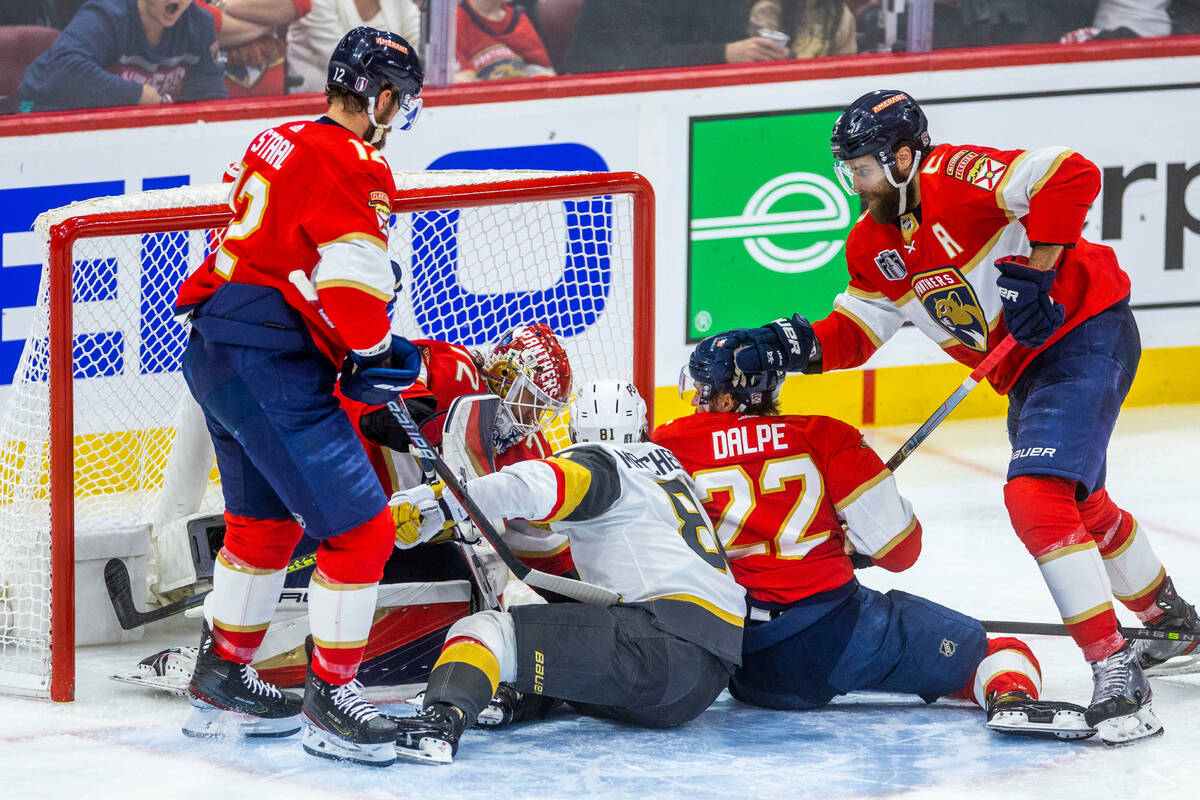 Golden Knights right wing Jonathan Marchessault (81) gets caught in the scrum as Florida Panthe ...