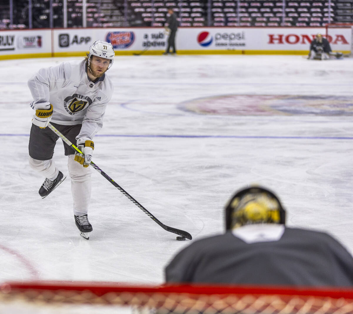 Golden Knights center William Karlsson (71) takes a shot at the net defended by goaltender Adin ...