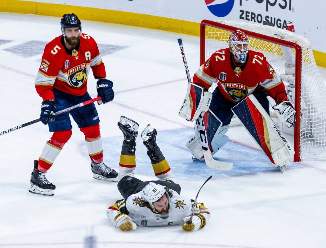 Golden Knights right wing Mark Stone (61) is checked to the ice by Florida Panthers defenseman ...