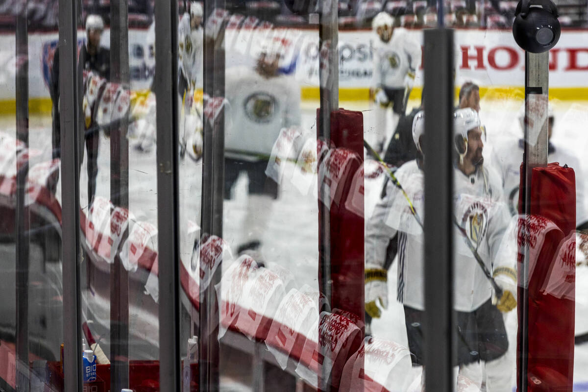 Golden Knights players skate on the ice as towels are hung on the seats during the morning skat ...