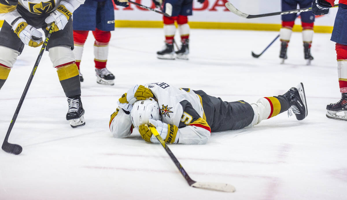 Golden Knights center Jack Eichel (9) lies injured on the ice against the Florida Pantghers in ...