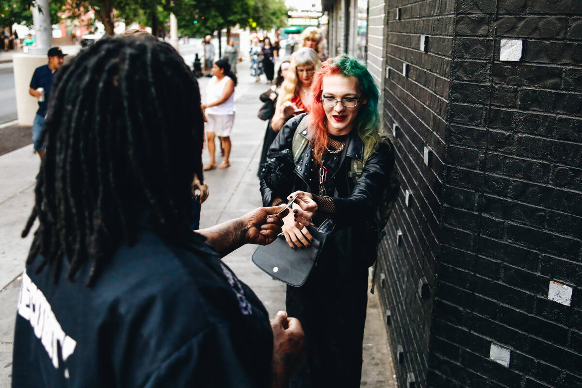 Rachel Billman hands her drivers license to a bouncer before entering the third annual Second C ...