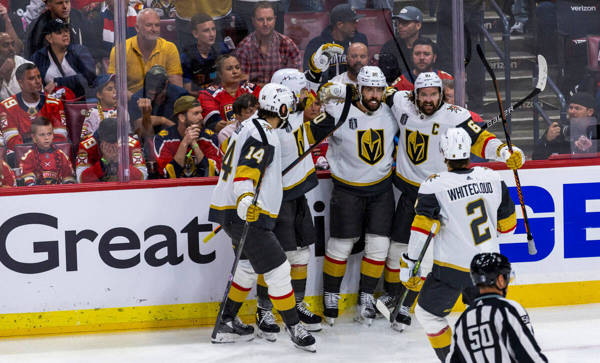 Golden Knights center Chandler Stephenson (20) with teammates celebrate his first goal in perio ...