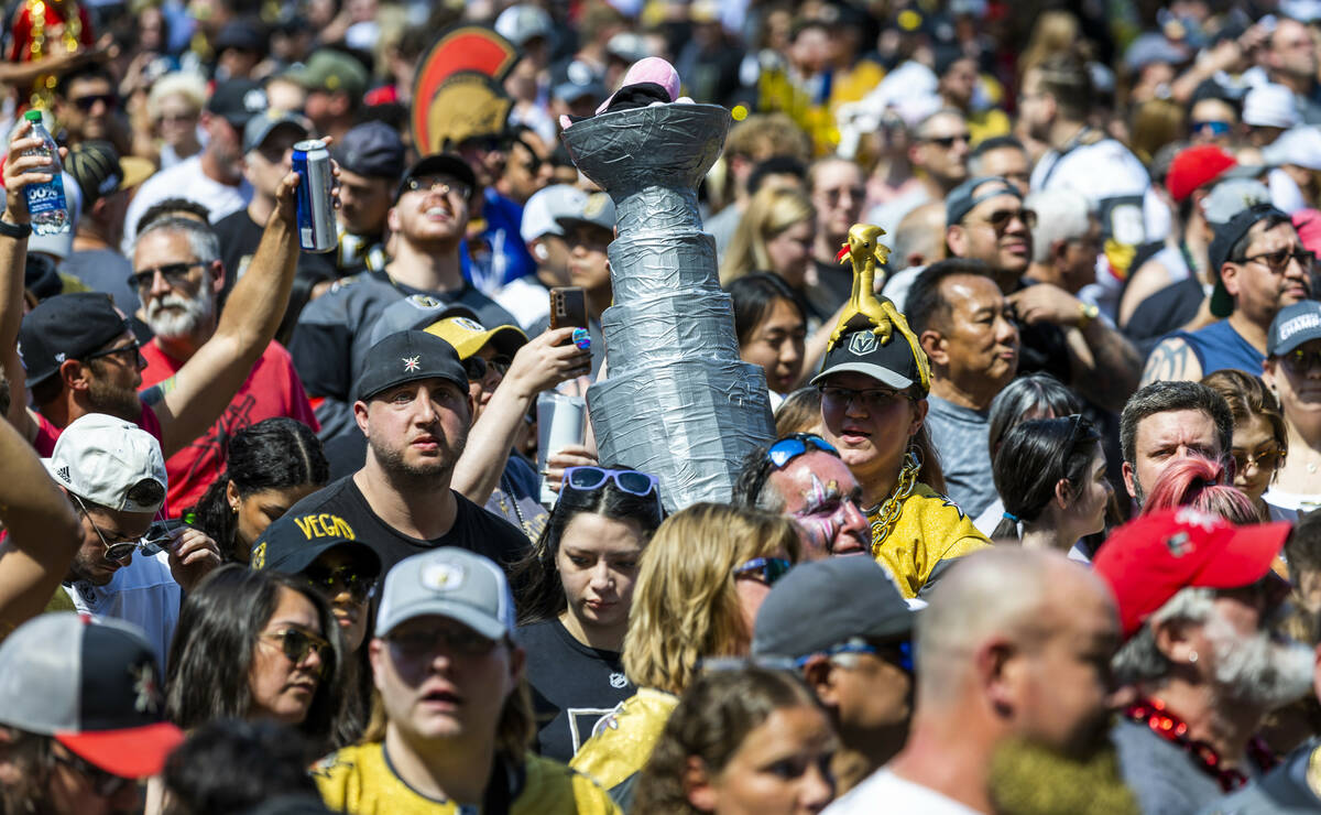 Golden Knights fan Jourdan Lasko of Henderson with her homemade trophy with other fans outside ...